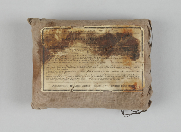 Kleiner Verbandskoffer mit einer Informationsseite obenauf.