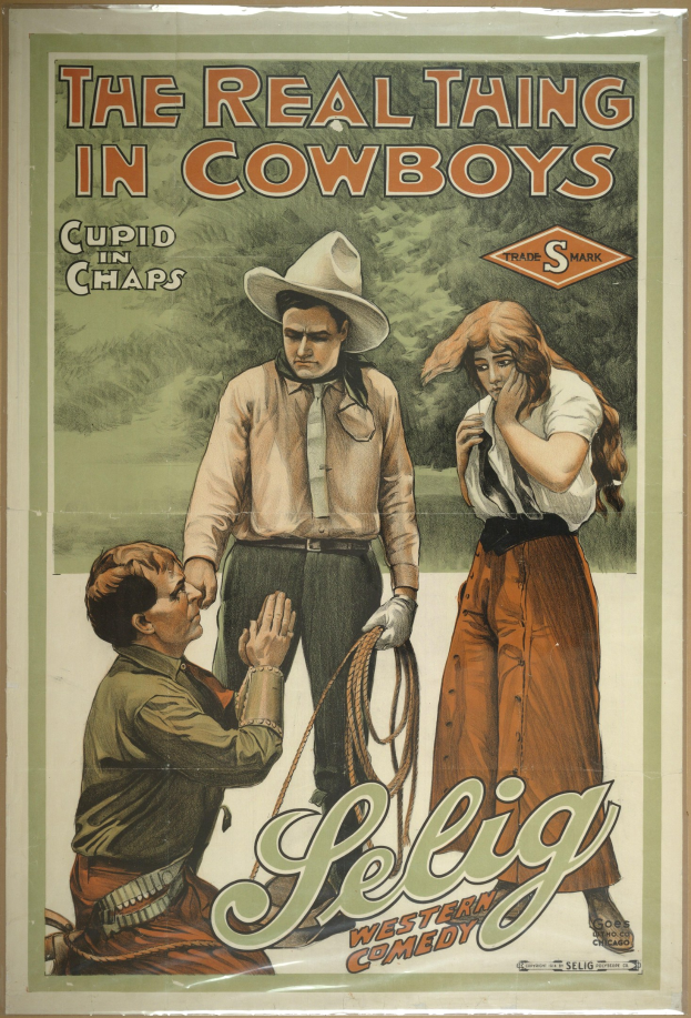 Plakat an einer Wand mit drei Personen in Cowboy-Kleidung und "The Real Thing in Cowboys" in fetter Schrift darüber, vor einem hellgelben Hintergrund.