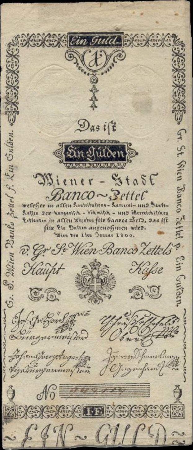 Ein altes deutsches Banknoten mit schwarzem Hintergrund, das das Gesicht eines Mannes und den Text "St. Wien - Stäse Banco-Settel" zeigt.